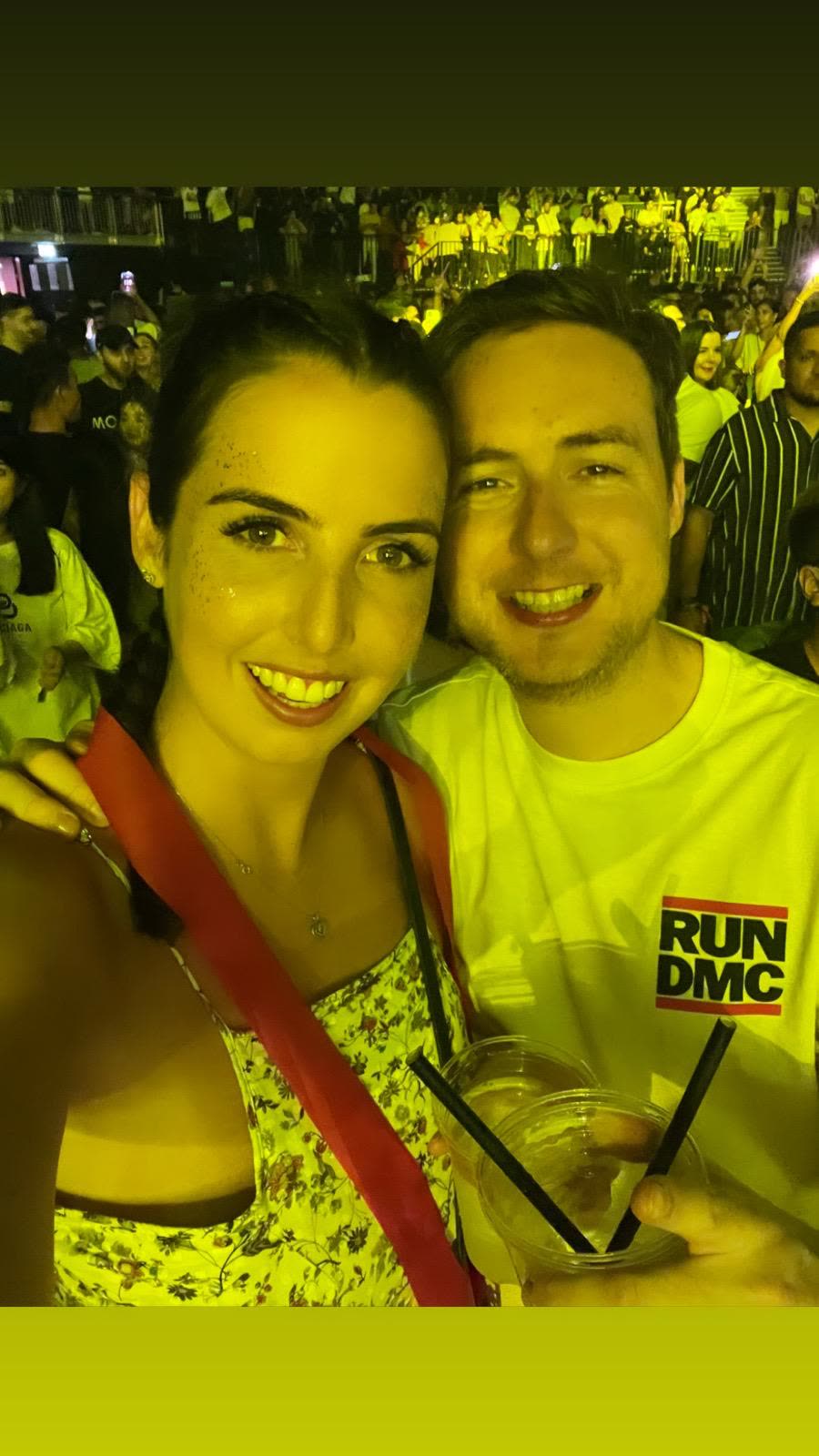 At a concert under yellow lights