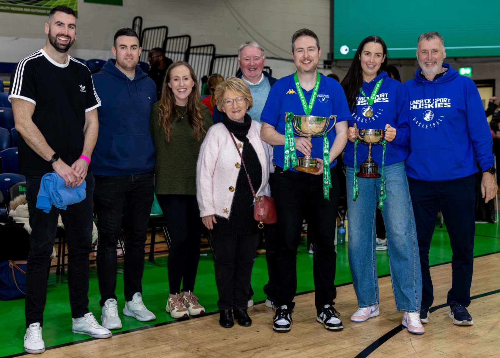 The whole family group on court with trophies on cup day